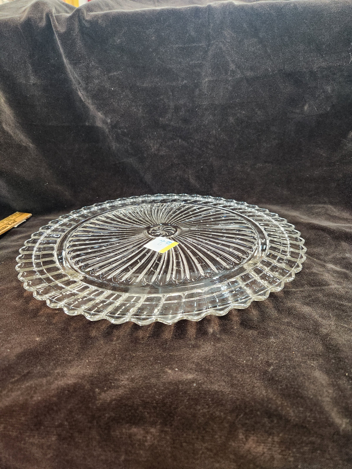 Clear Pressed Glass Cake Plate Featuring a Radiating Swirl Pattern and a Scalloped Rim